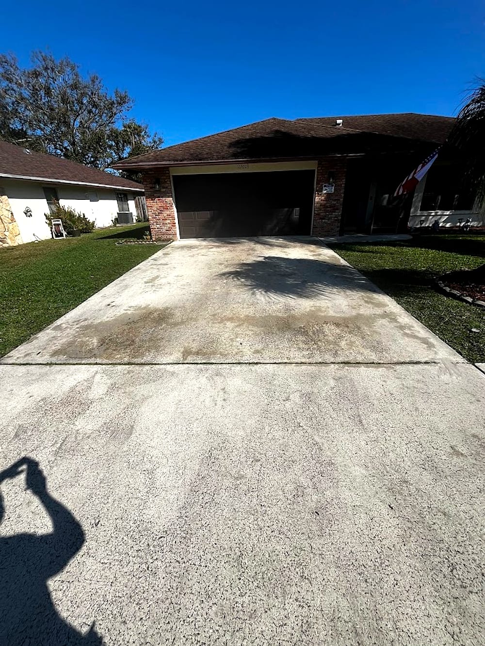 Stained, weathered South Florida driveway before pressure washing