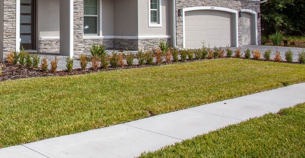 The same walkway restored to bright, clean concrete